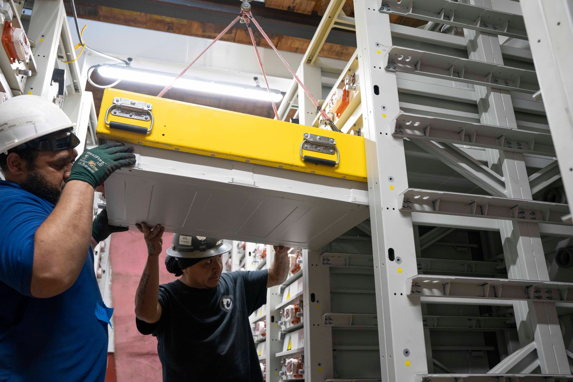 Installing battery module into racks.
