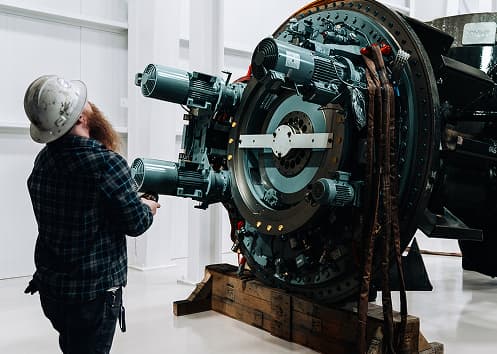 A technician working on Arc's electric powertrain motor assembly.