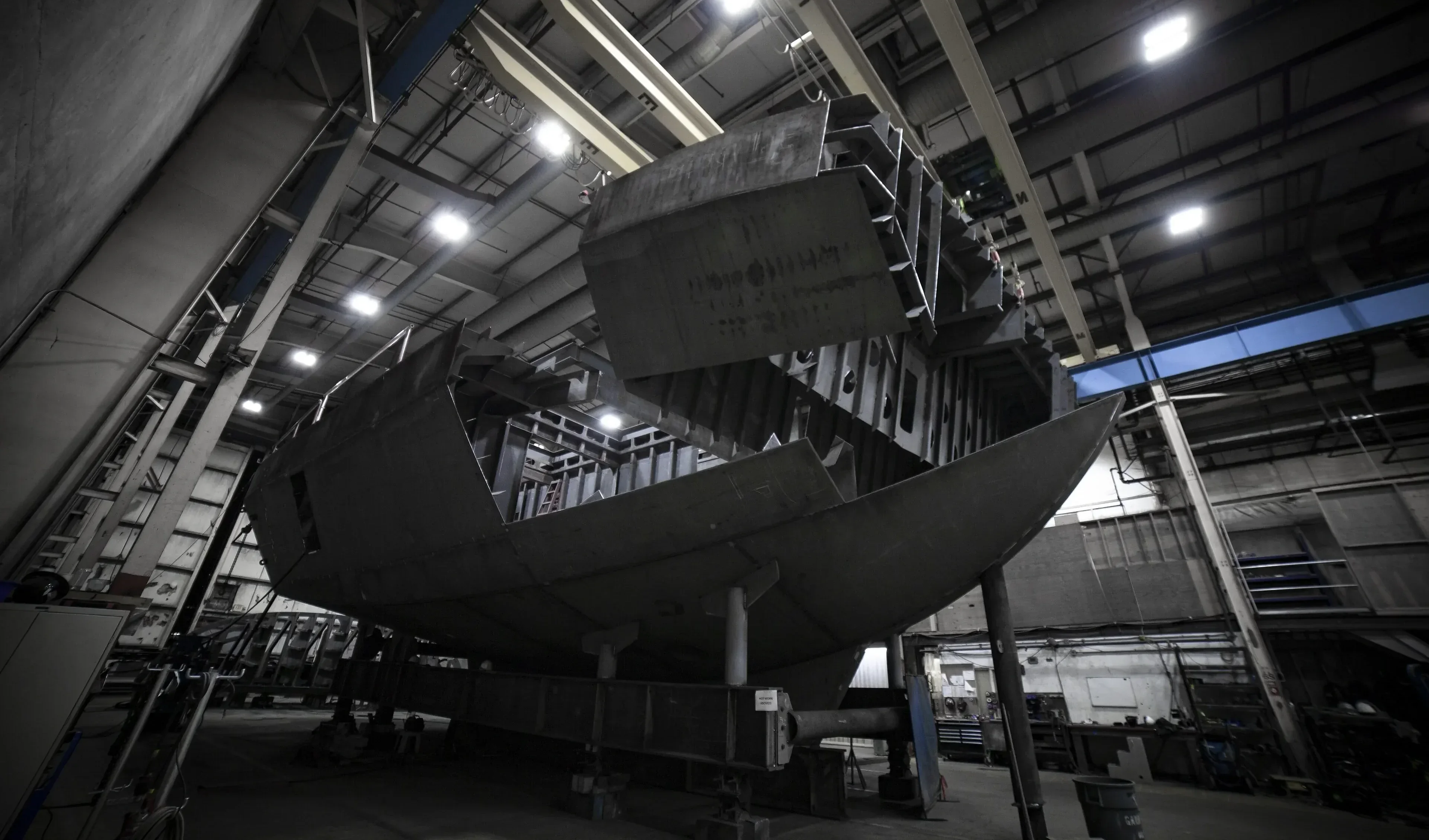 A photograph of an electric tugboat hull under construction.
