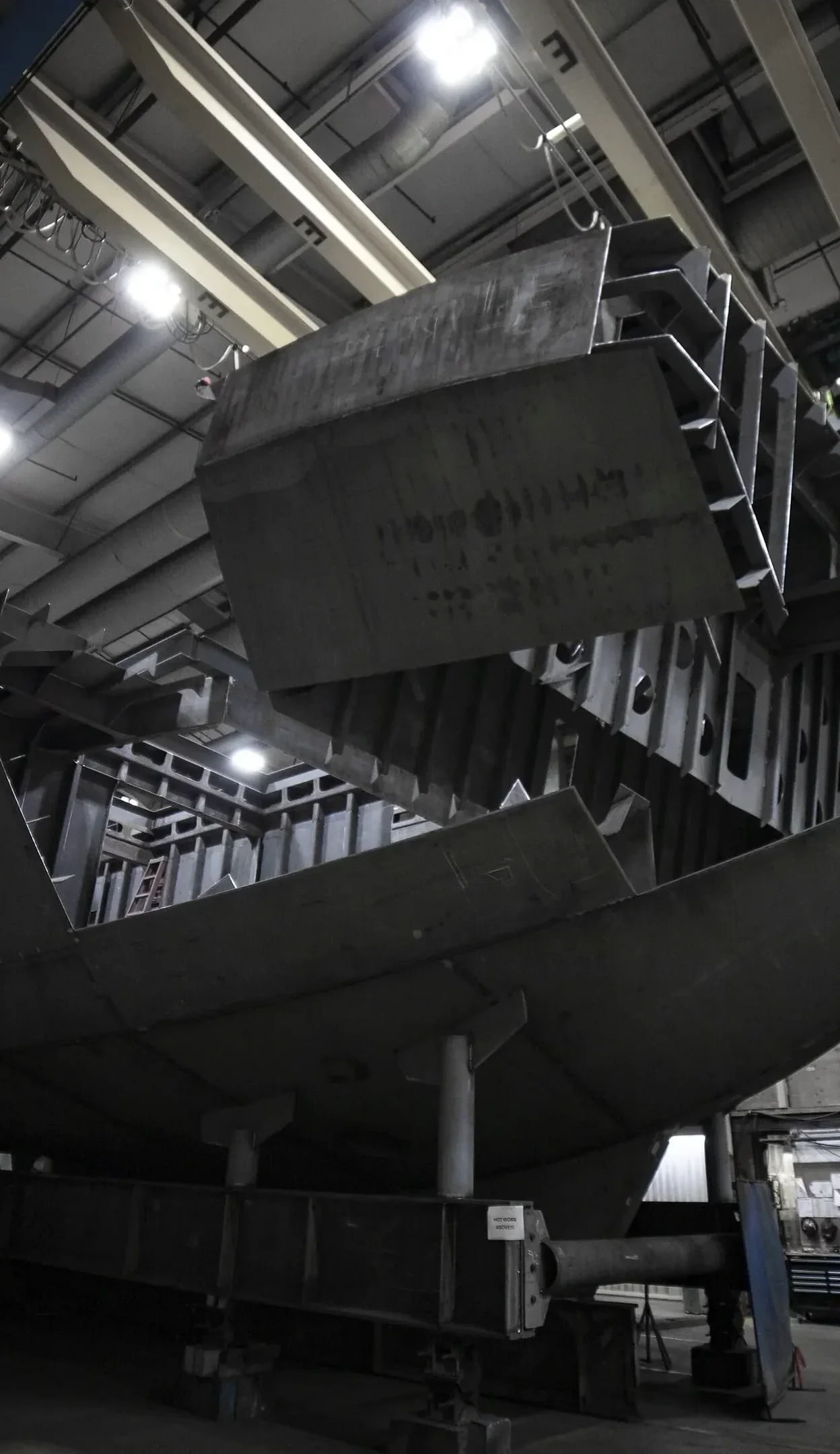 A photograph of an electric tugboat hull under construction.