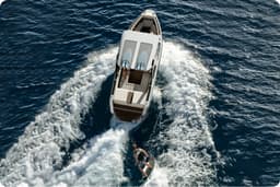 An aerial photograph of an EV boat navigating the water.