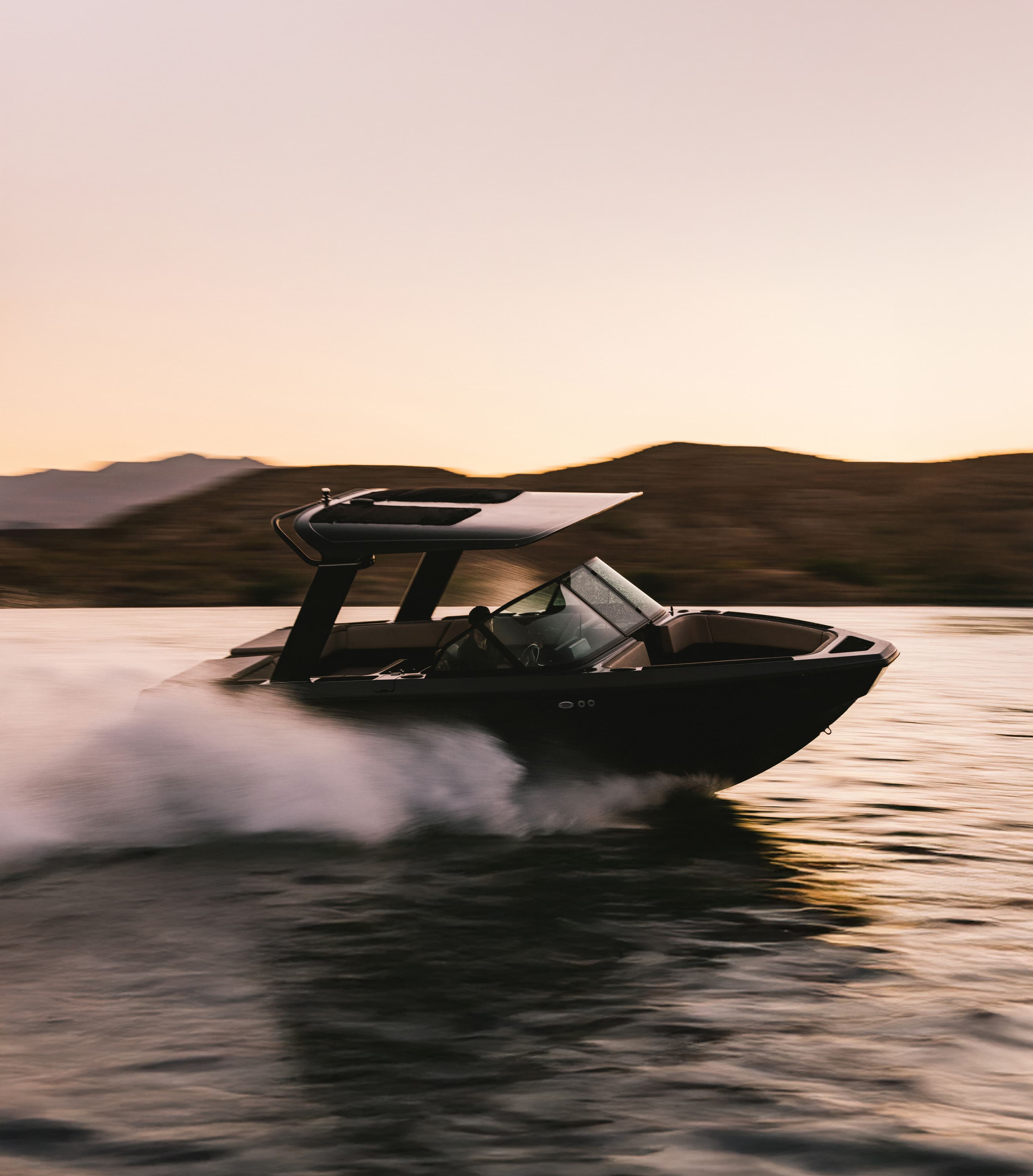 A photograph of an EV boat zipping through the water