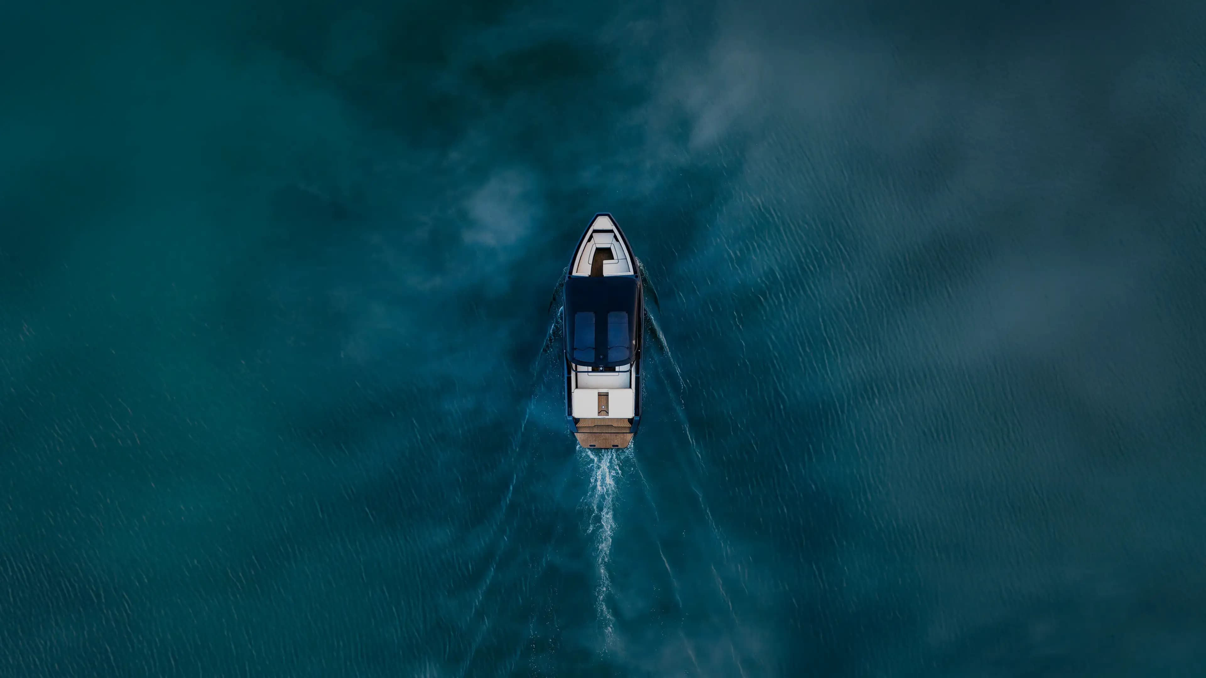 A photograph of a top-down drone view of a boat on the water.