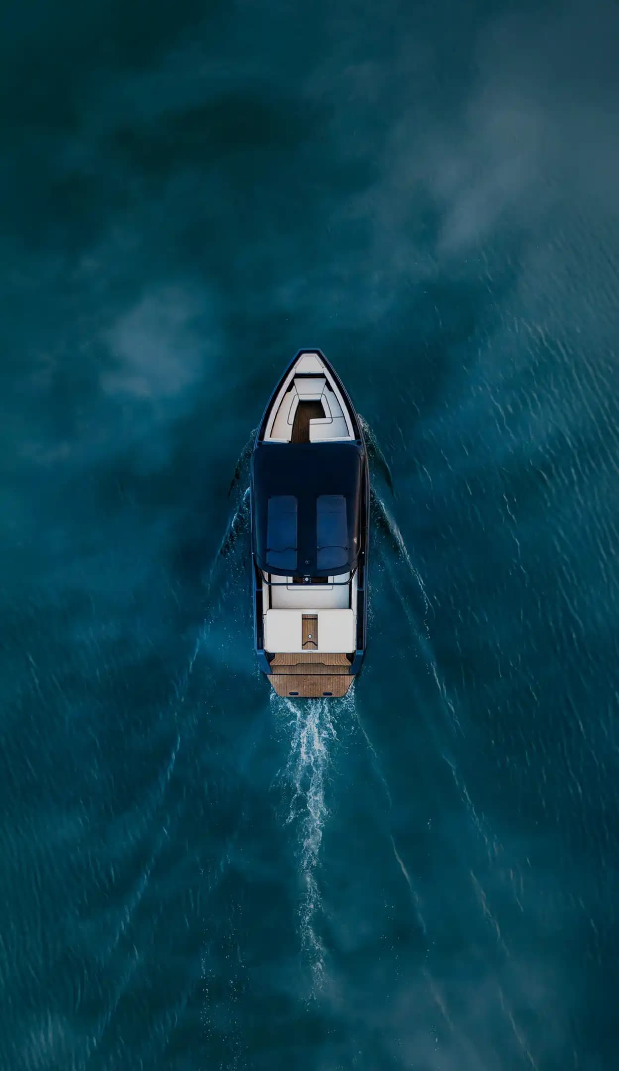 A photograph of a top-down drone view of a boat on the water.