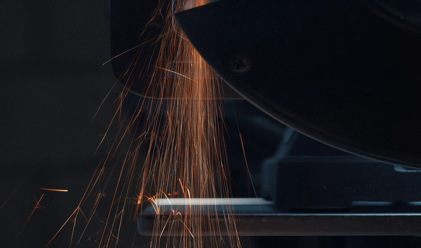 Sparks from a welder working on an Arc One hull inside the factory