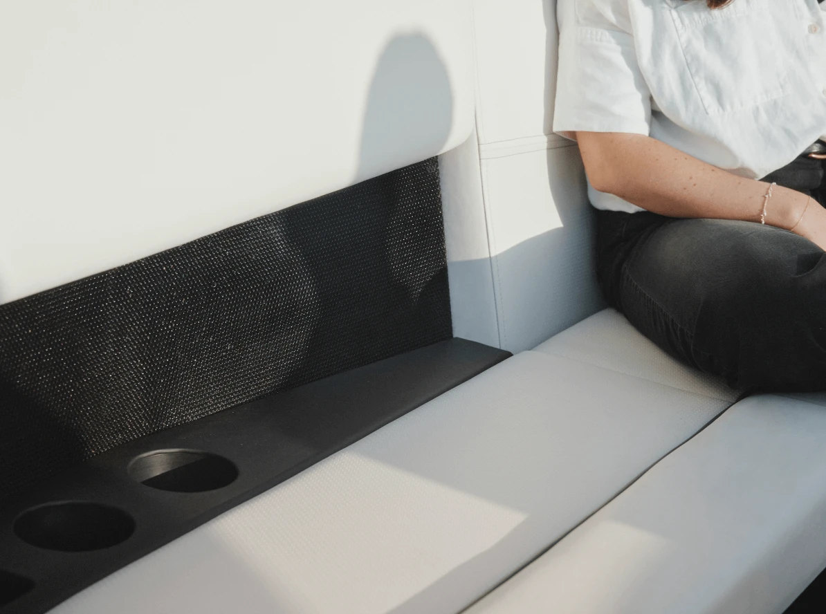 A closeup view of one of the Arc One seats, speakers, cup holders, and phone charging stations