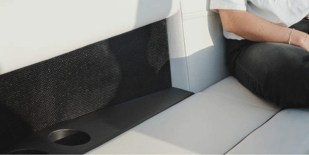 A closeup view of one of the Arc One seats, speakers, cup holders, and phone charging stations
