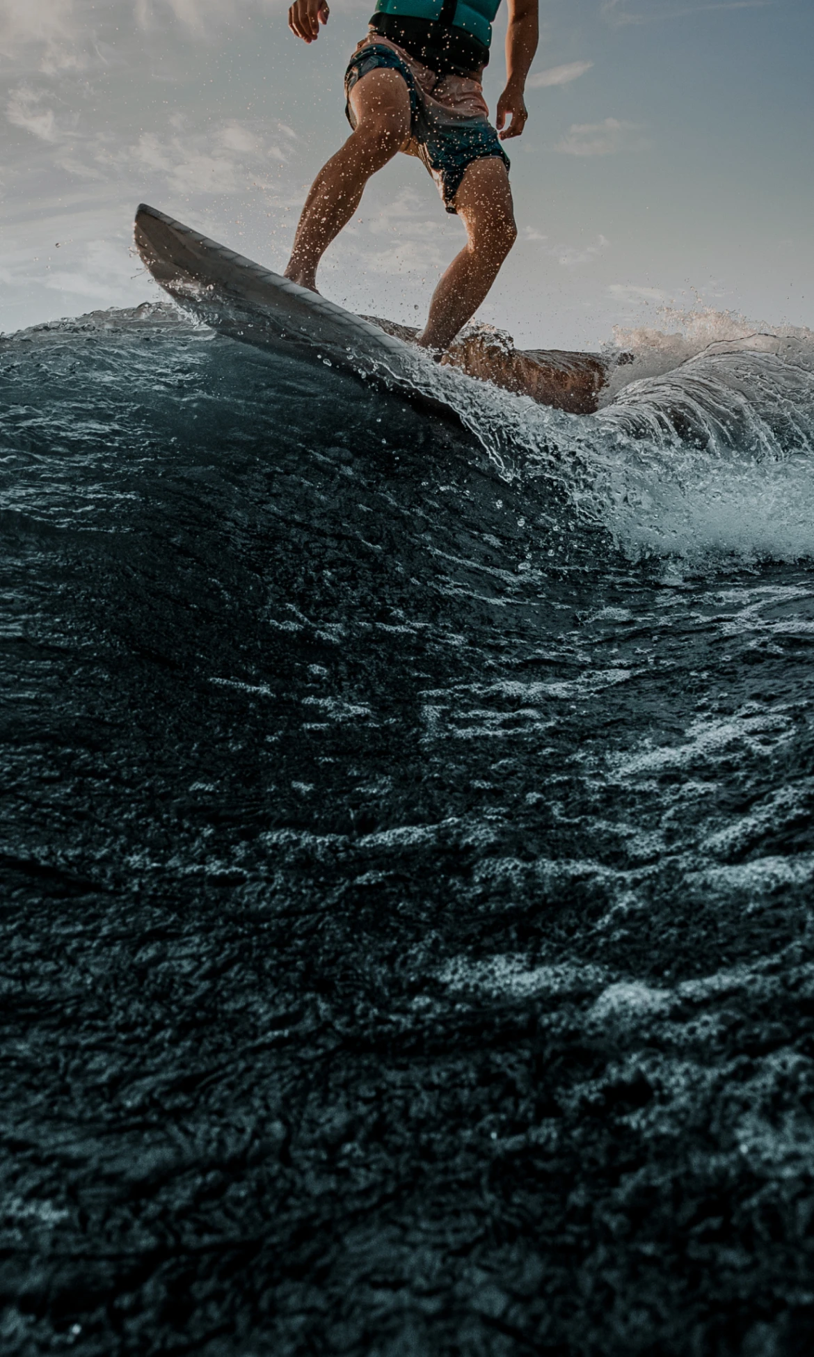 A surfer riding a deep blue wave